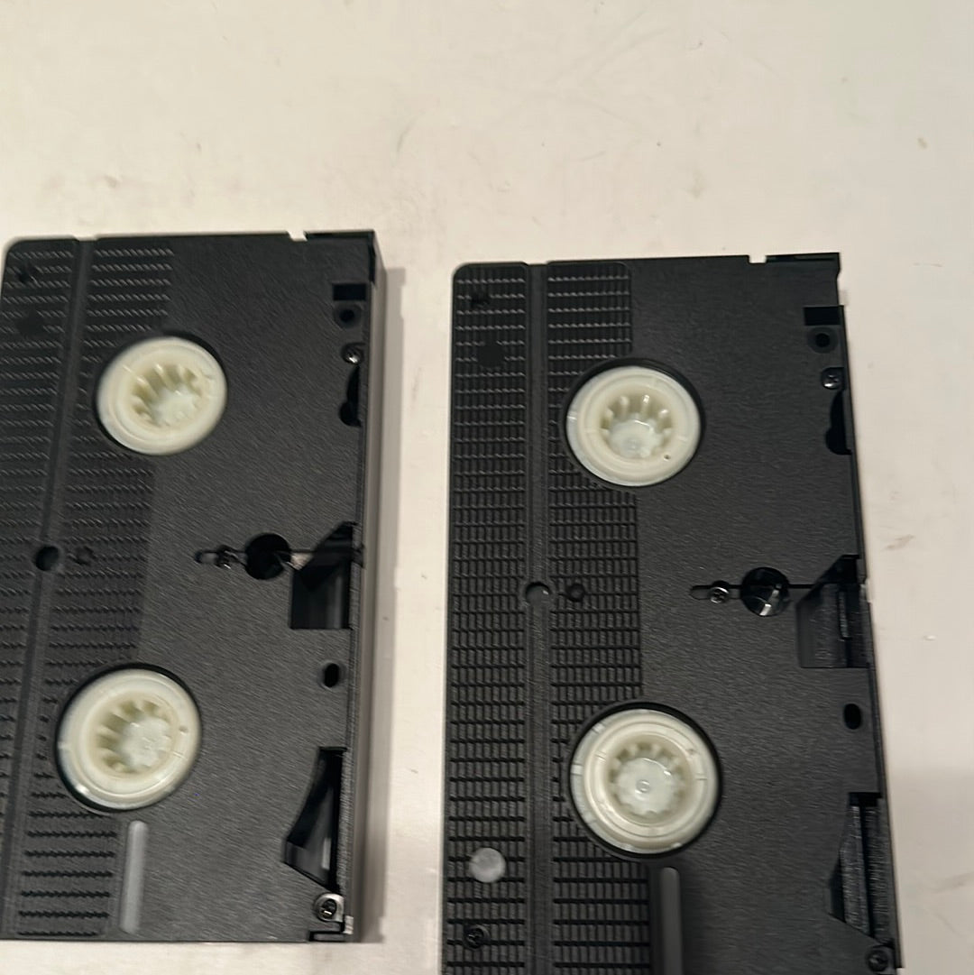 Two black VHS tapes from the Basil Rathbone VHS collection by EveryMailBox placed on a white surface
