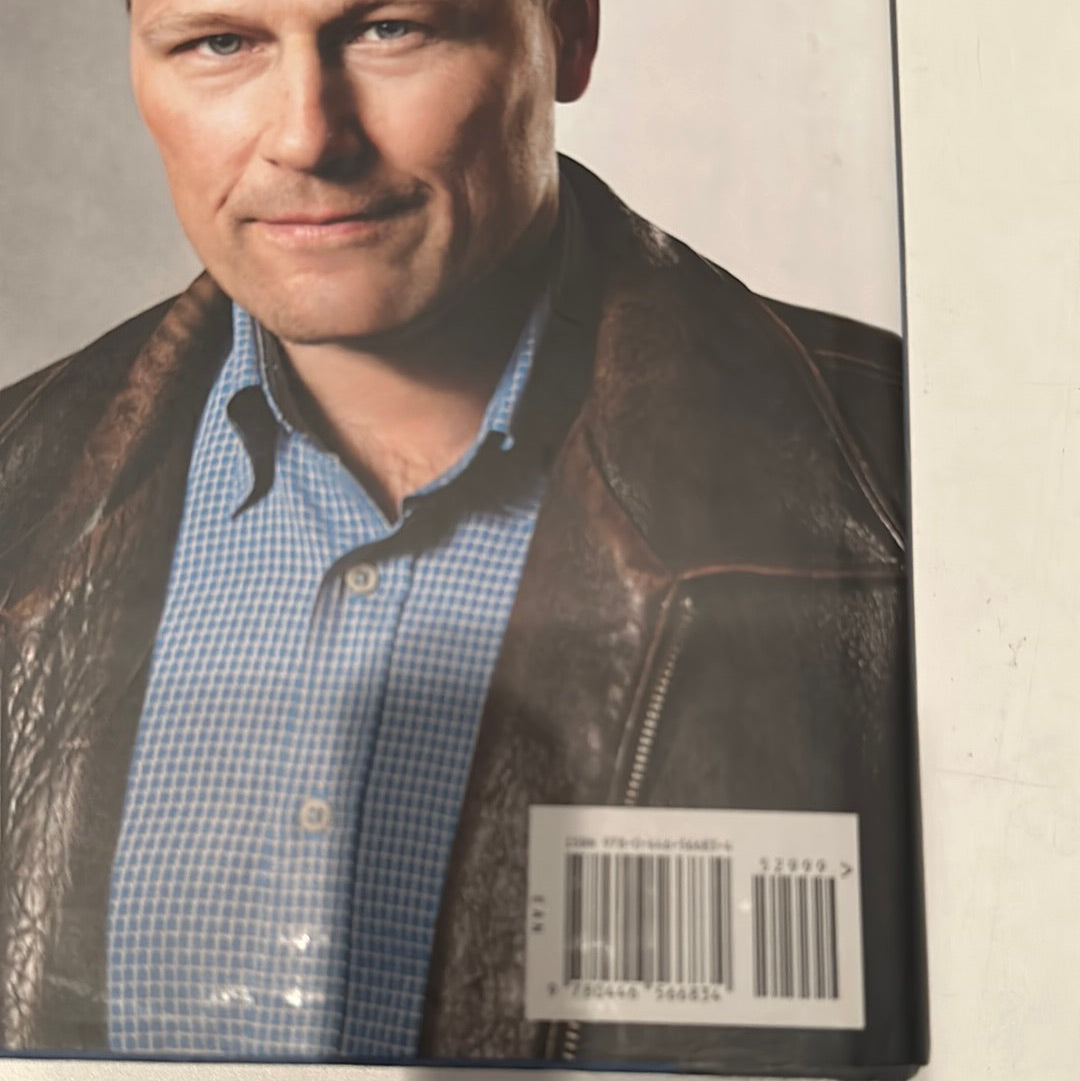 Close-up of a man wearing a leather jacket on the back cover of a David Baldacci thriller novel