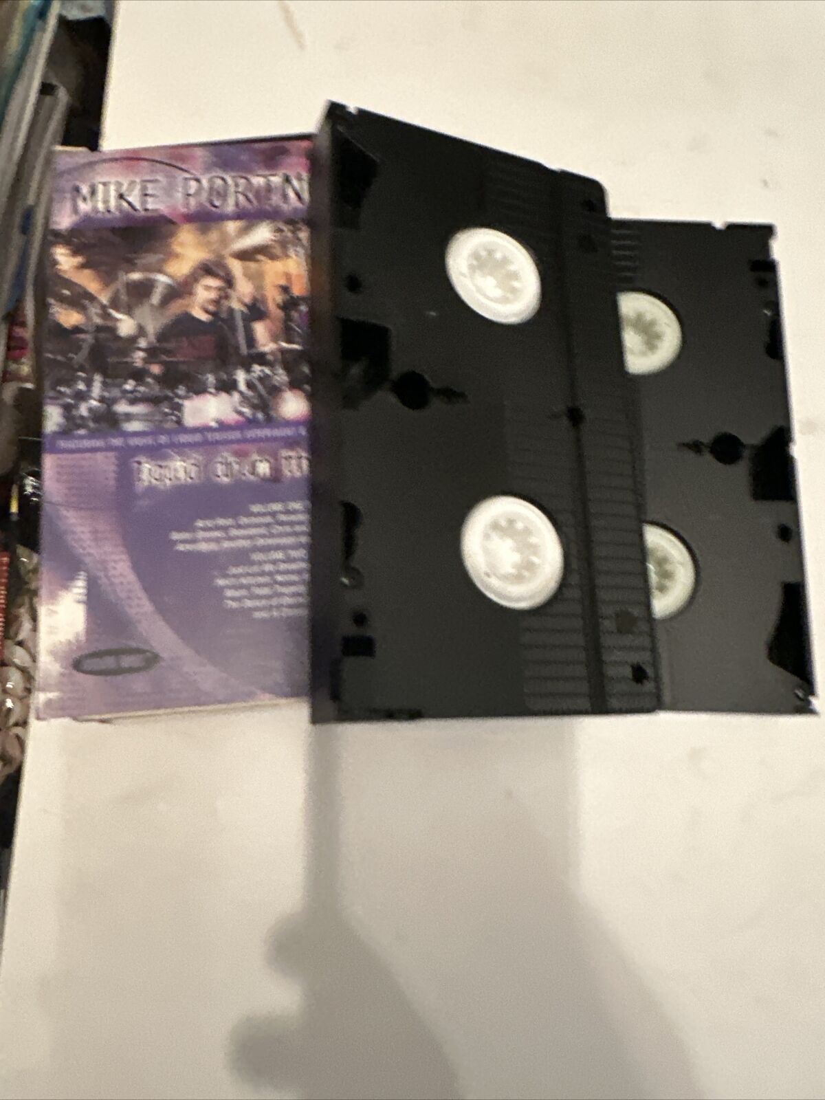 Mike Portnoy Liquid Drum Theater VHS two black VHS tapes laid beside purple cover jacket