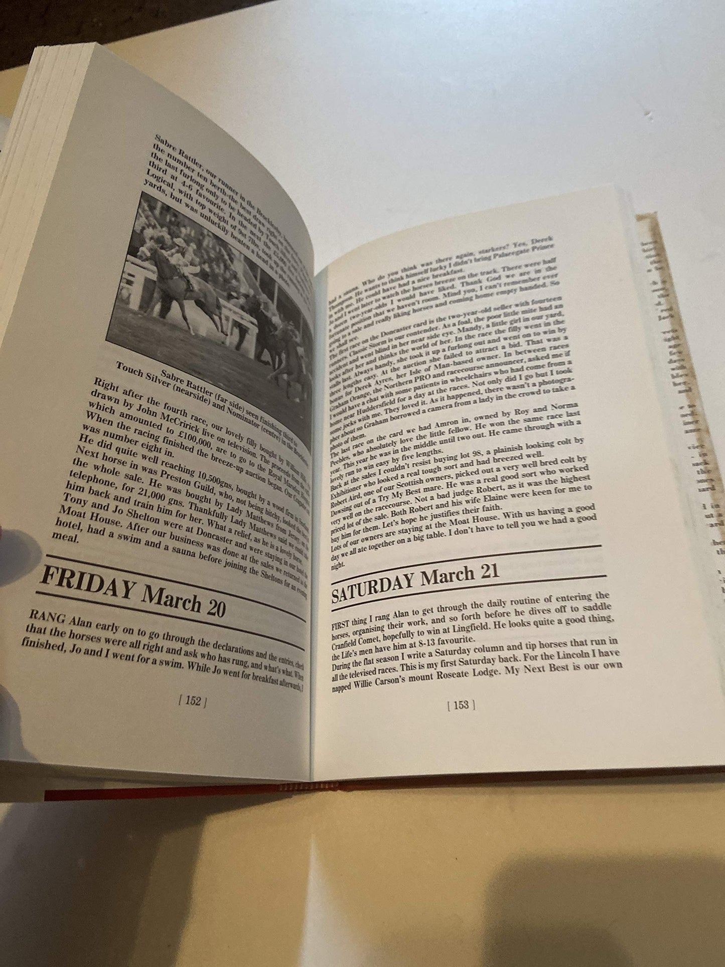 Open pages of Red Shirts historical novel showing text and a black and white photograph on a table