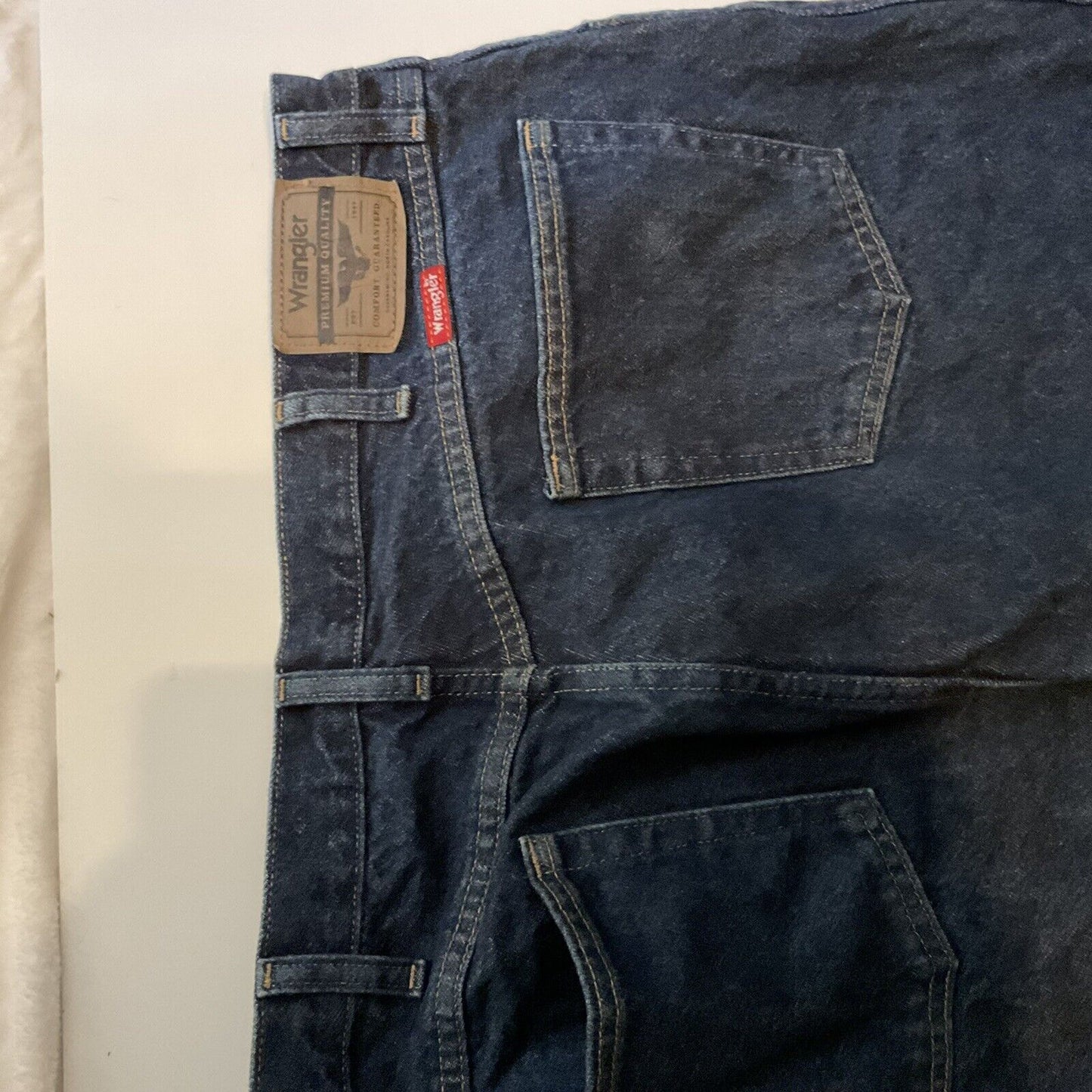 Wrangler relaxed fit jeans men dark blue denim back view showing waistband leather patch and back pockets