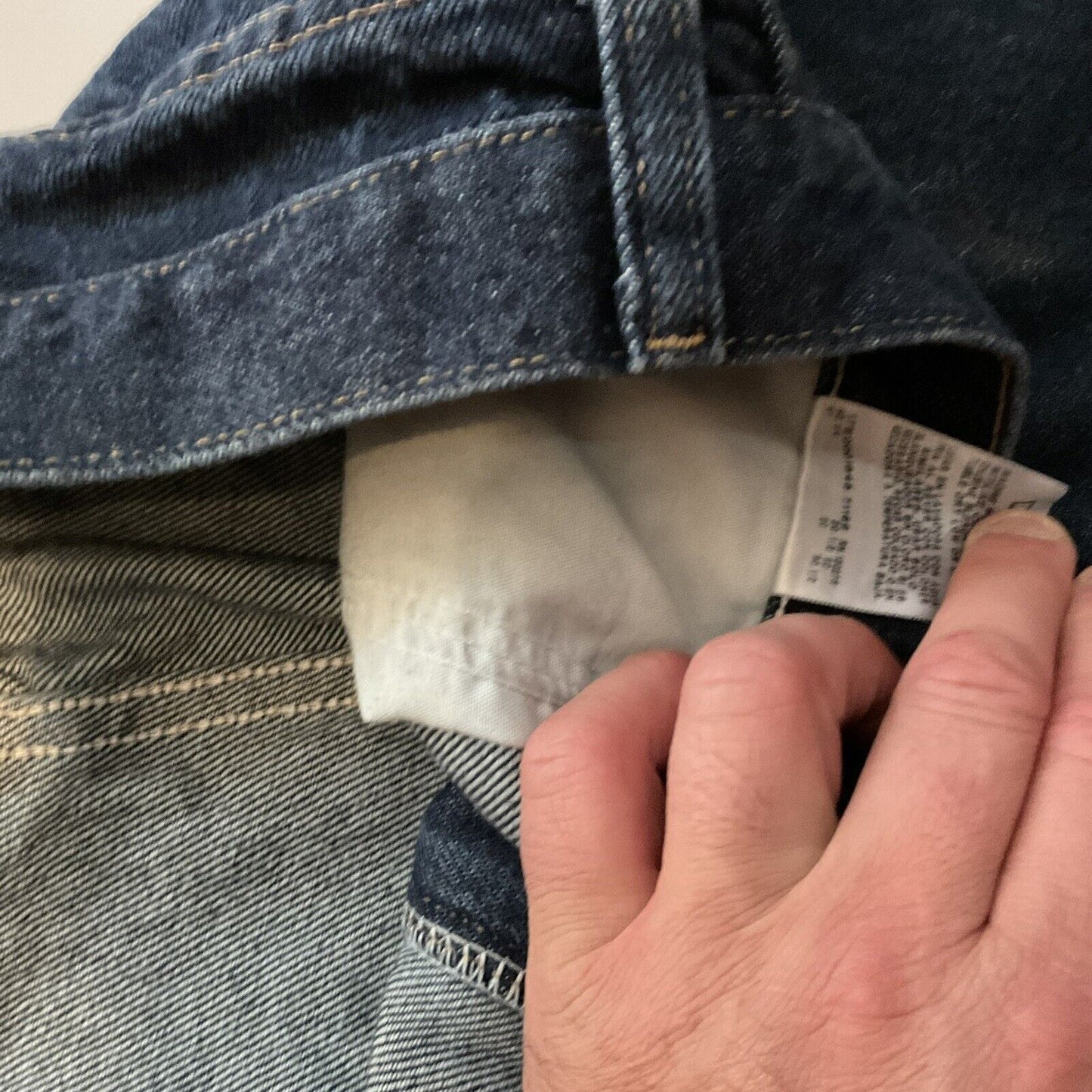 Wrangler relaxed fit jeans men dark blue denim hand pulling inner pocket lining care tag and belt loop