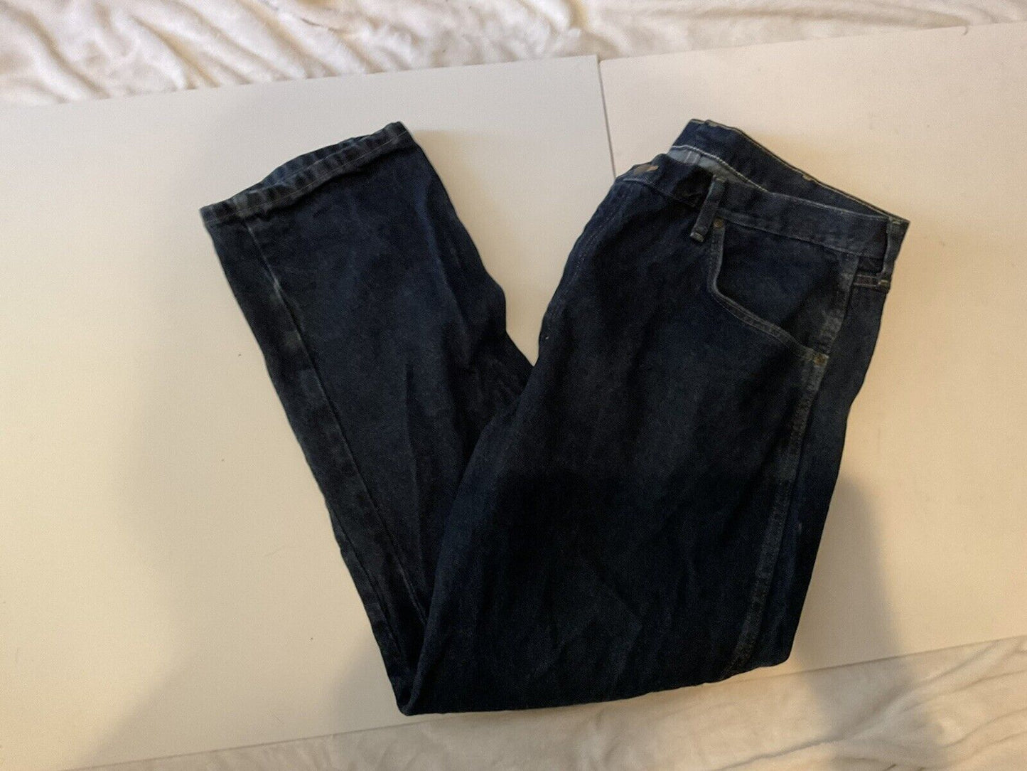 Wrangler relaxed fit jeans men dark blue denim folded flat showing front pocket and straight leg casual style