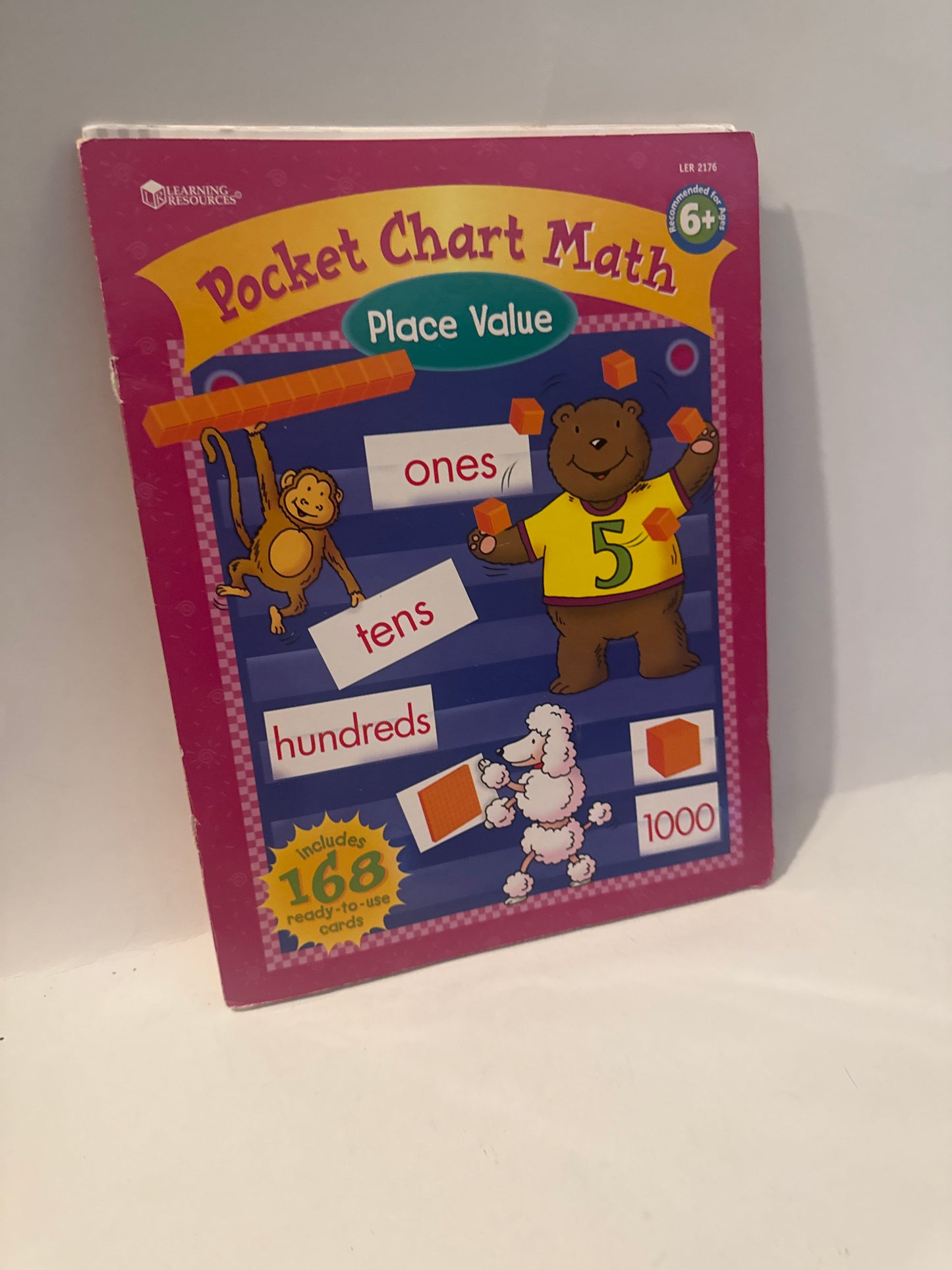 “Classroom pocket chart showing place value columns from ones to thousands