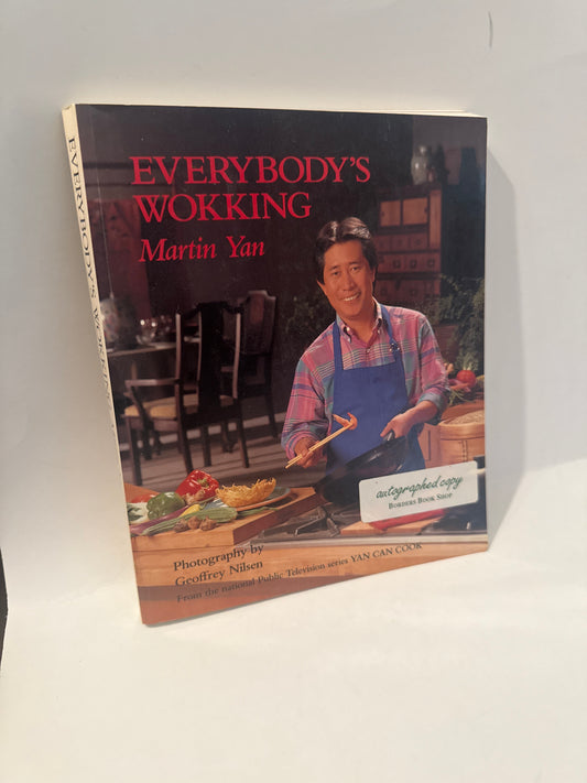 Cover of “Everybody’s Wokking” cookbook by Martin Yan, featuring the author in a vibrant kitchen with fresh veggies and wok, autographed copy.
