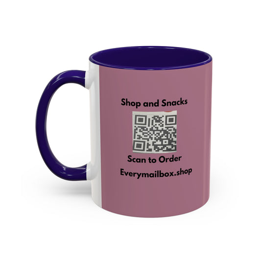 A ceramic mug with a mauve-pink exterior, a dark purple handle and interior, and a white vertical band on the left side. The front features black text reading 'Shop and Snacks' above a QR code and 'Scan to Order' and 'Everymailbox.
