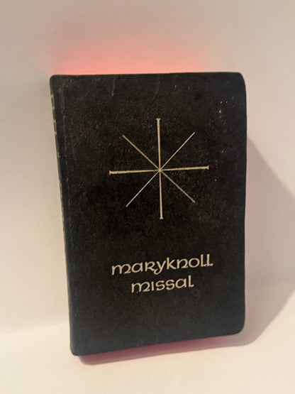 Vintage Maryknoll Missal with minimalist white star emblem on black cover