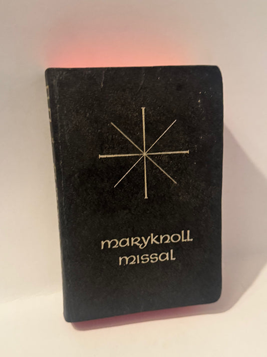 Vintage Maryknoll Missal with minimalist white star emblem on black cover