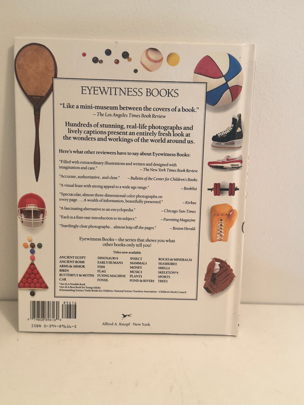 Back cover of Eyewitness Books Sports edition with sports equipment illustrations and book description