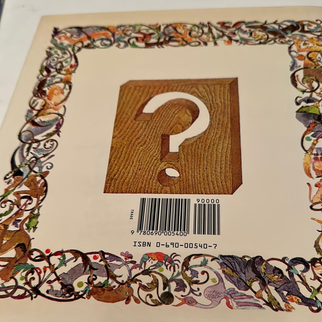 Back cover of Anno's Alphabet book featuring decorative floral border and a wooden block with a question mark