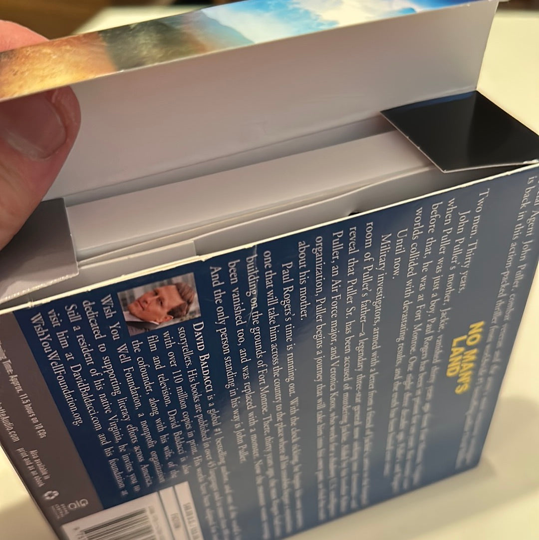 Back cover of David Baldacci No Man's Land book showing synopsis and author photo held open