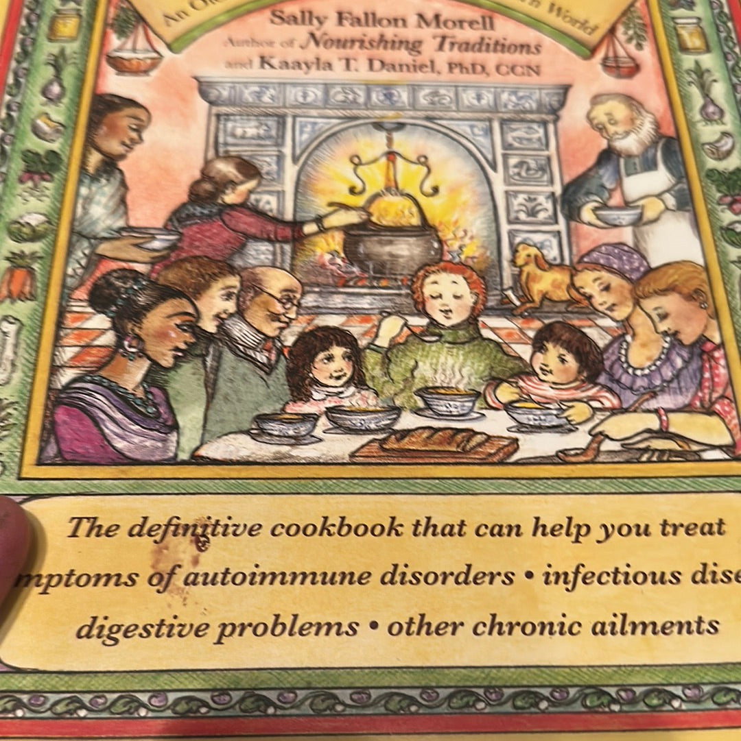 Cookbook cover featuring a family enjoying easy healthy broth for autoimmune support by the fireplace