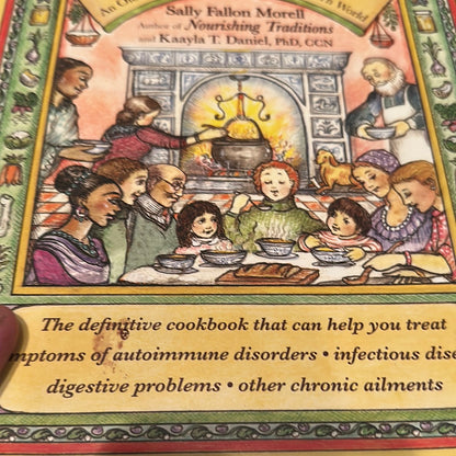 Cookbook cover featuring a family enjoying easy healthy broth for autoimmune support by the fireplace