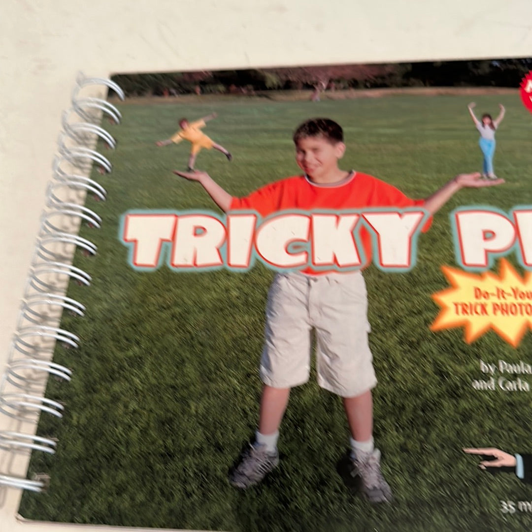 EveryMailBox tricky pix photo book with spiral binding showing a boy holding two tiny people on his hands in a park background