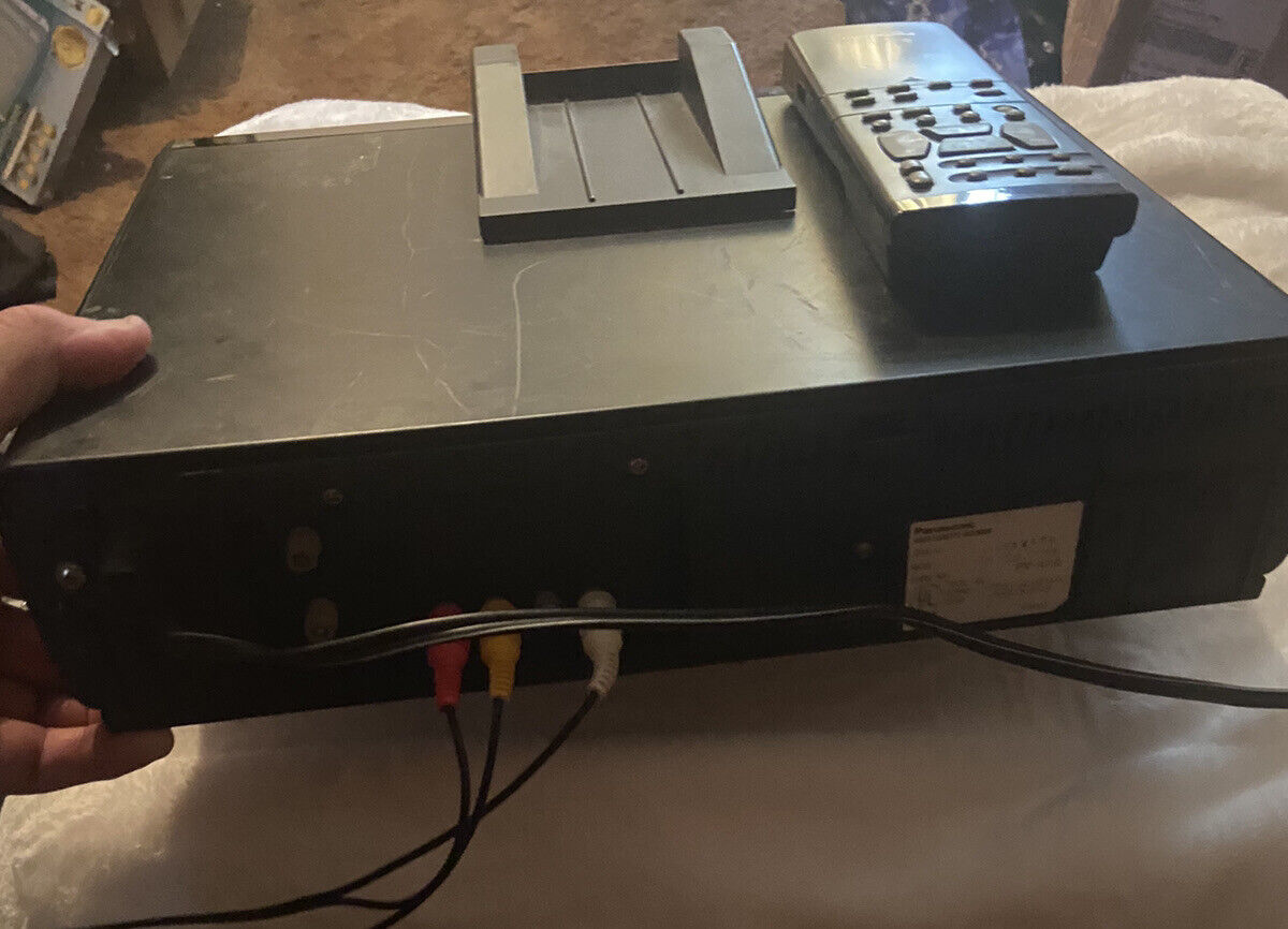 Black Panasonic OmniVision VHS player with remote on top and red yellow white composite cables connected