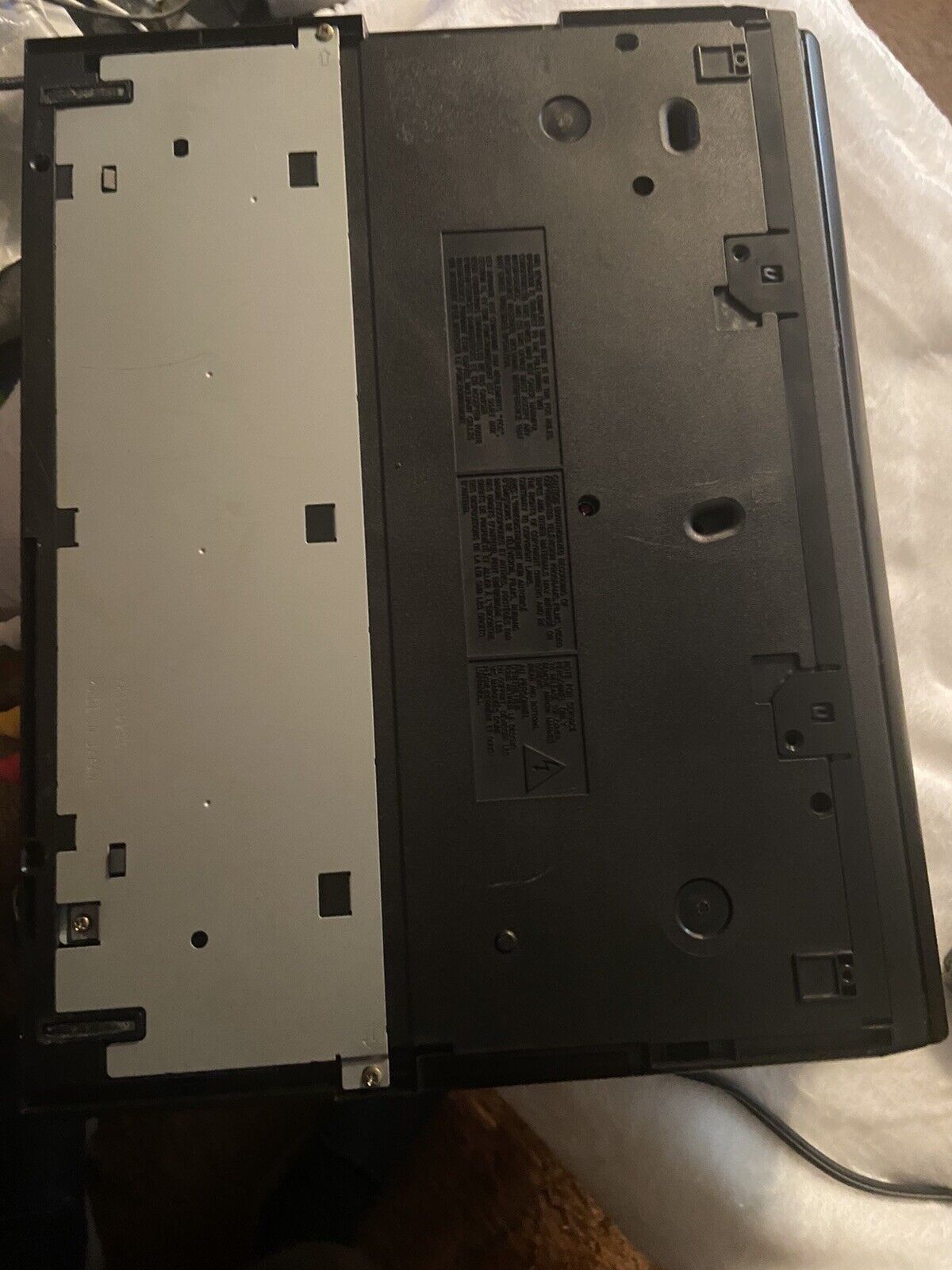 Panasonic OmniVision VHS player bottom view showing black underside panel screws model label and power cord