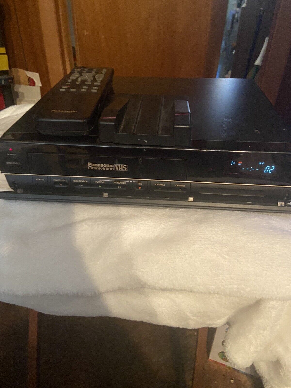 Panasonic OmniVision VHS player black VCR with remote on top and digital display front panel