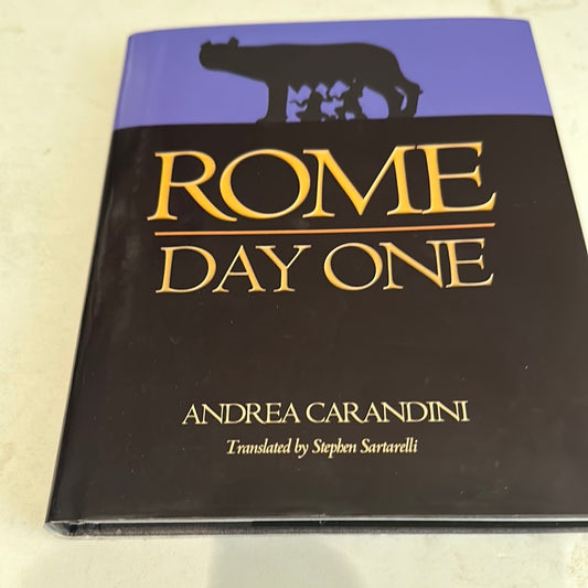 Rome Day One book by Andrea Carandini with black and purple cover featuring Roman wolf illustration