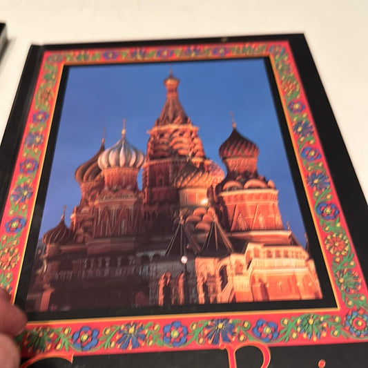 Colorful Russian Christmas history book cover featuring Saint Basil's Cathedral with decorative floral border