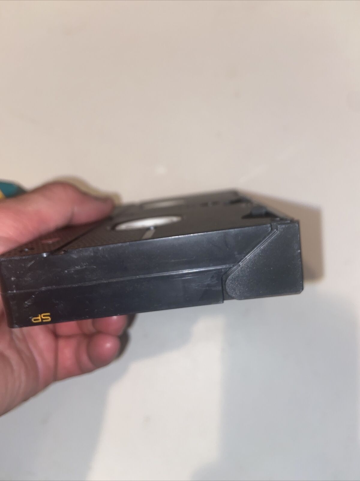 Handheld black VHS cassette with worn corner labeled SP featuring Thomas The Tank Engine rare VHS collectible