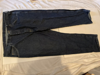 Wrangler relaxed fit jeans men dark indigo straight leg five pocket jeans laid flat on bed